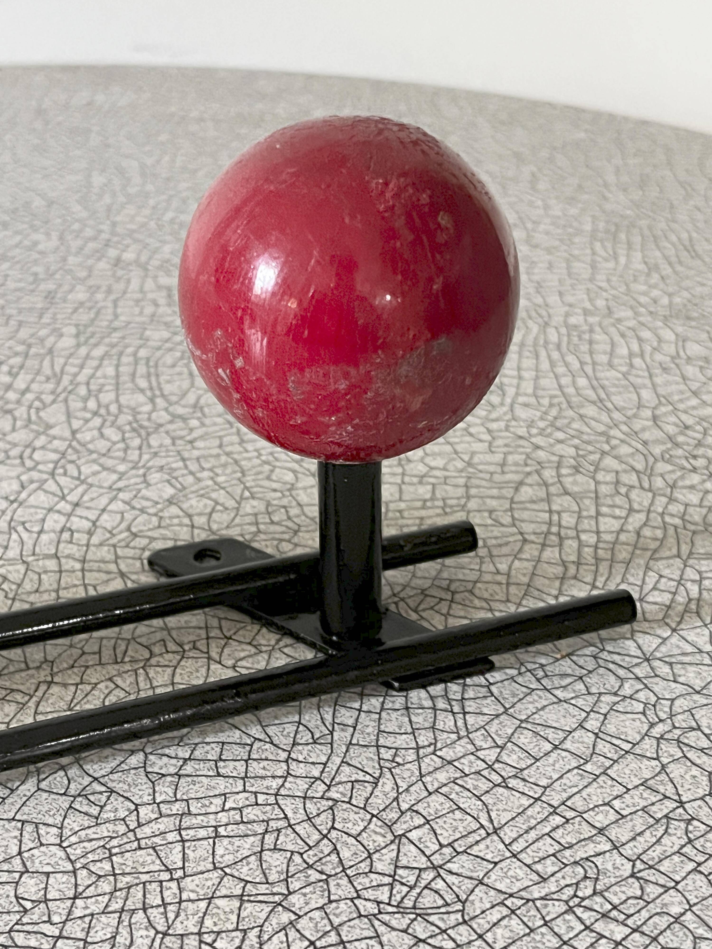 Vintage wall coat rack, metal and wood in yellow and red.
