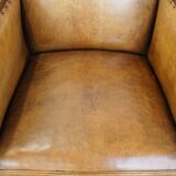Cognac-colored sheepskin and wooden Art Deco design armchair