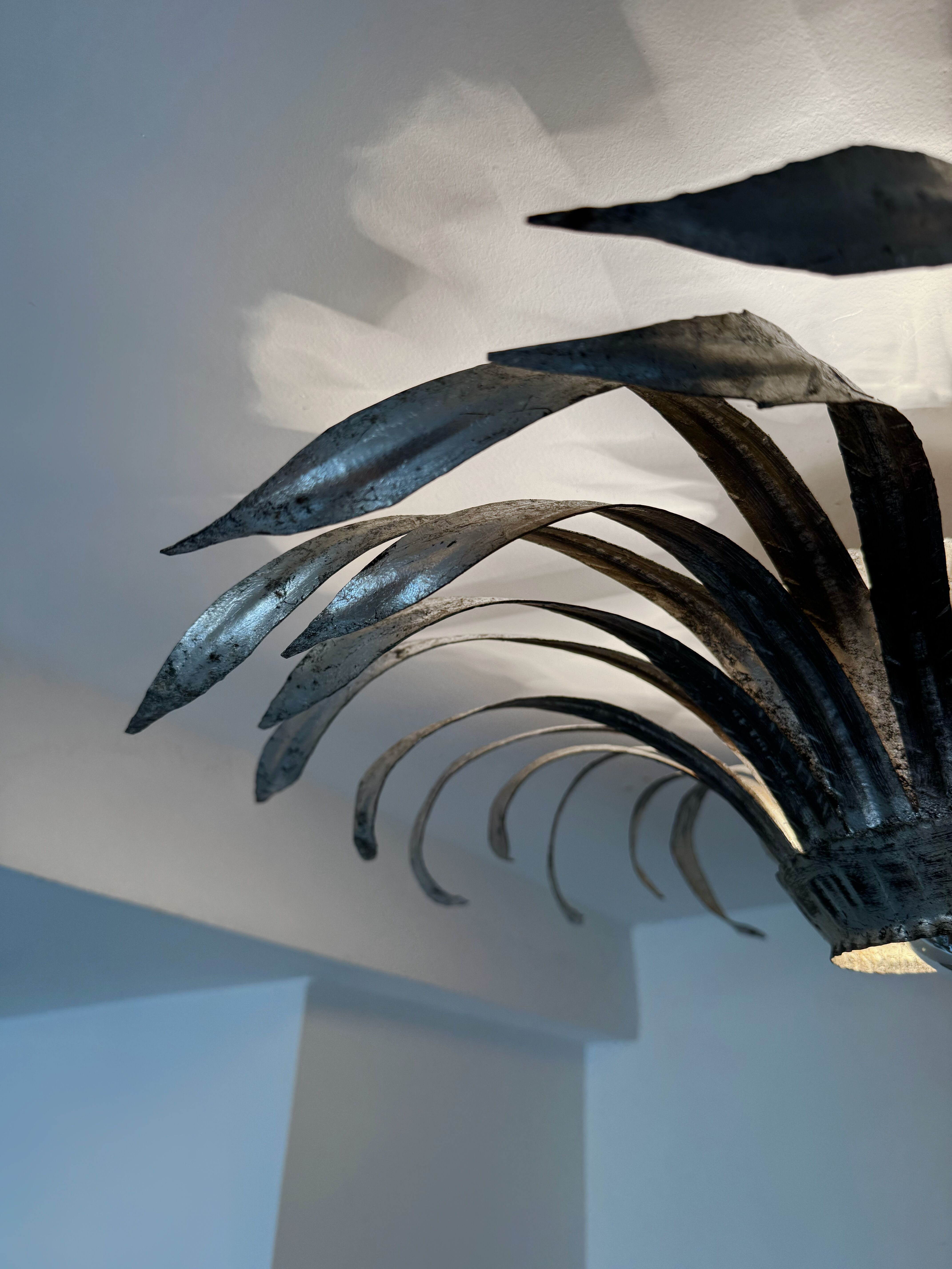 Silver wrought iron sunburst wall light from the 1960s.