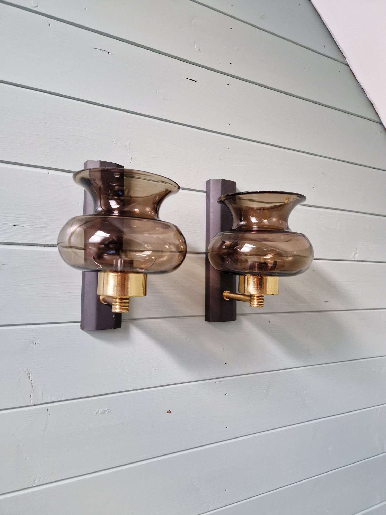 Pair of wall sconces in brass and smoked glass, 1960s.