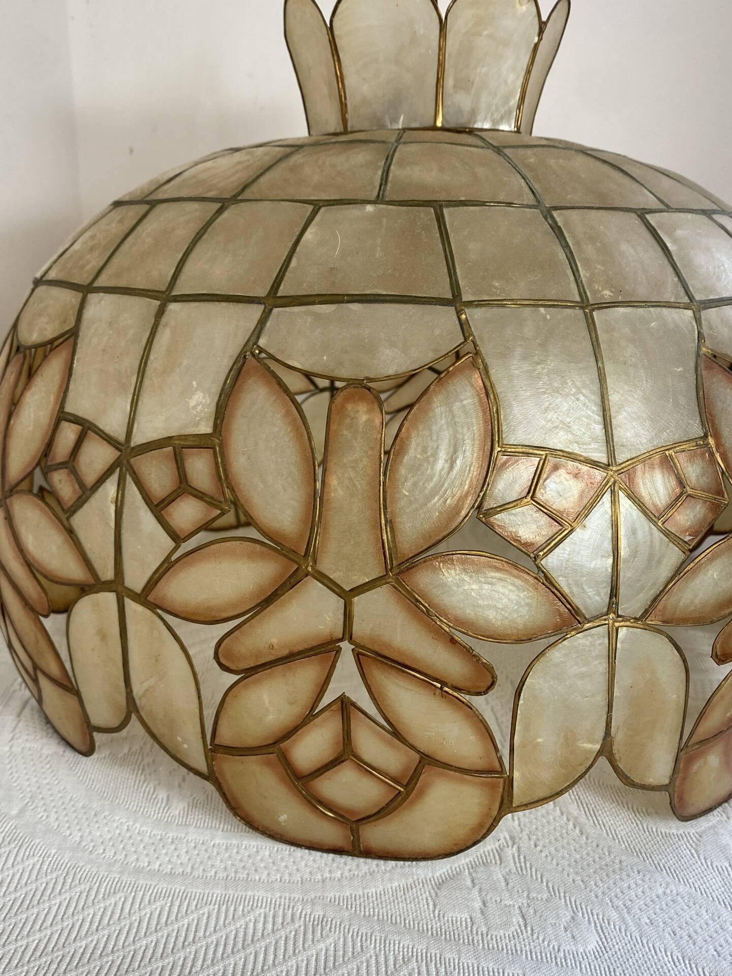 Large mother-of-pearl and brass chandelier with floral decoration.