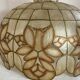 Large mother-of-pearl and brass chandelier with floral decoration.
