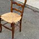Louis XV 18th century solid wood dining chair with a straw seat.