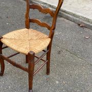 Louis XV 18th century solid wood dining chair with a straw seat.