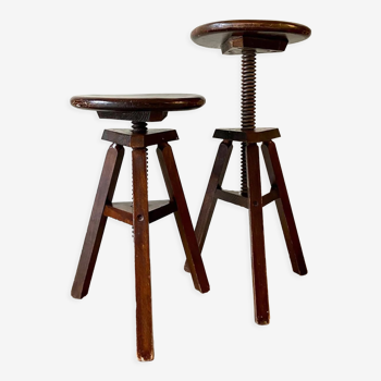 2 tripod stools with dark wood screws