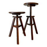 2 tripod stools with dark wood screws