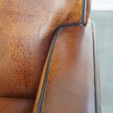 Art Deco design sheepskin leather armchair with a stunning patina