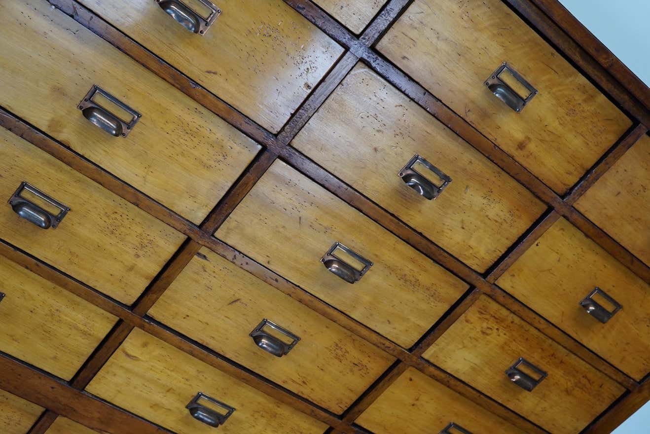 School cabinet bank of vintage Dutch drawers in mid-twentieth century pine