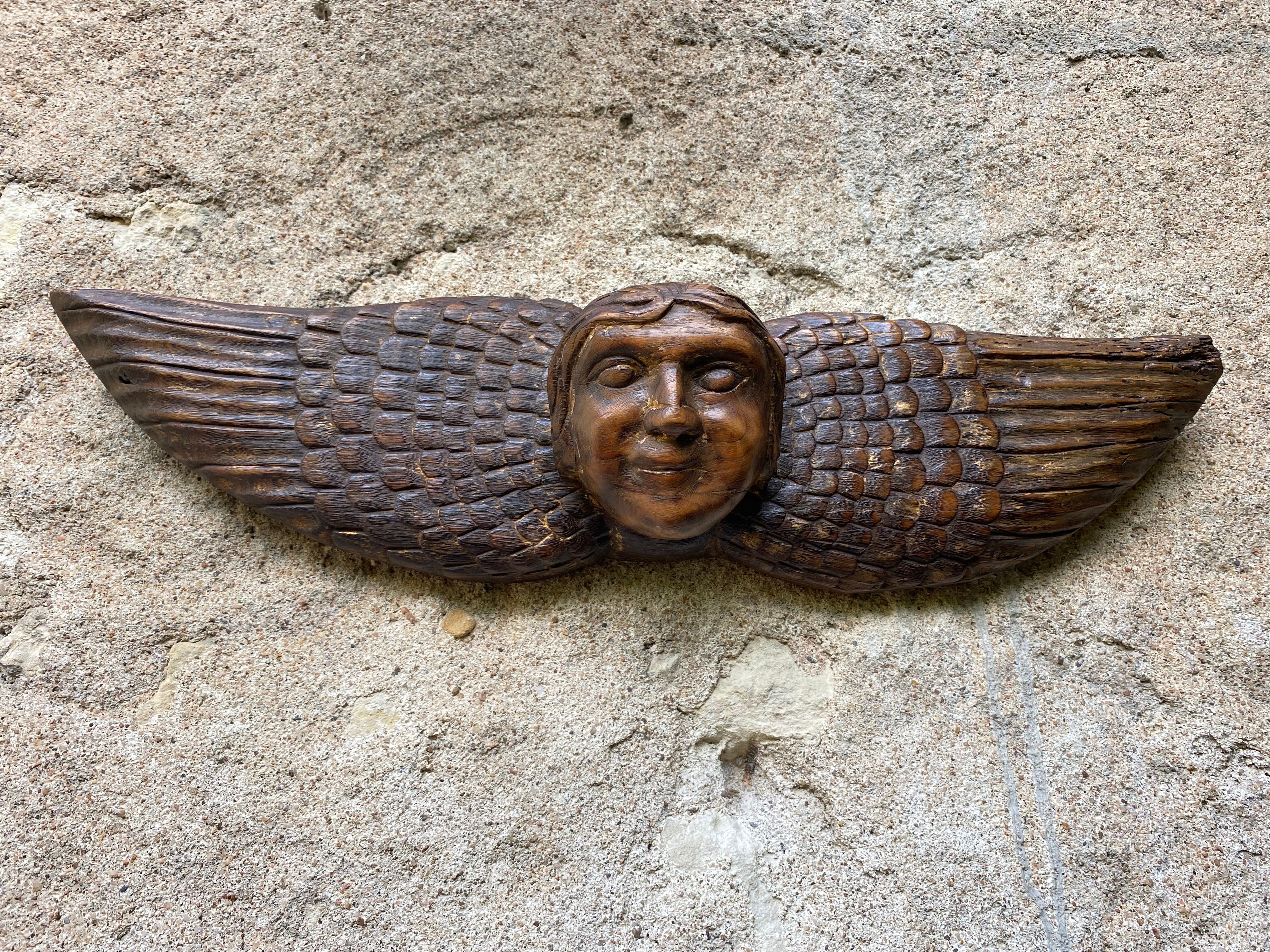 Carved wooden angel head