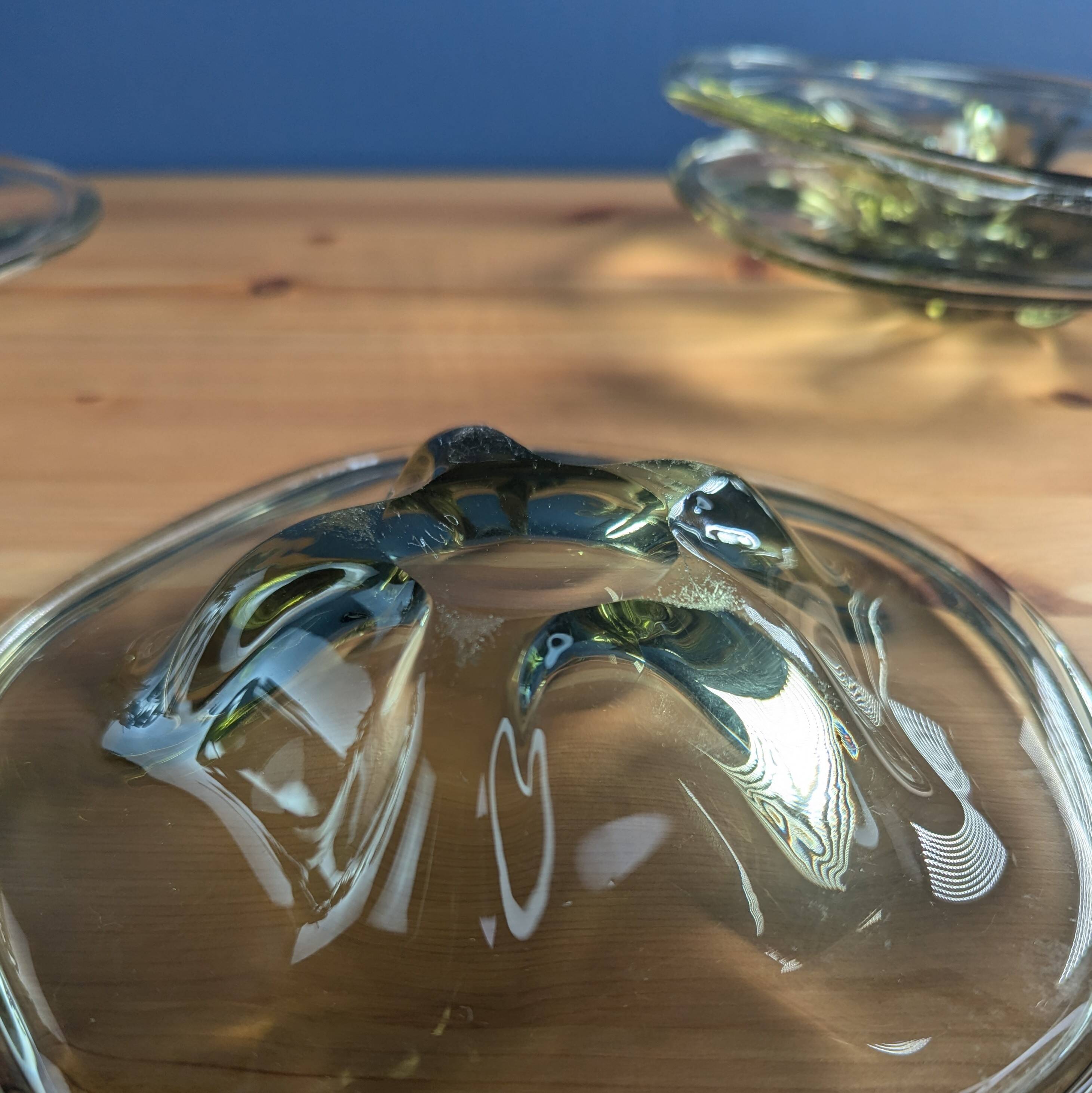 4 wavy glass bowls plates in smoked green design, signed and numbered