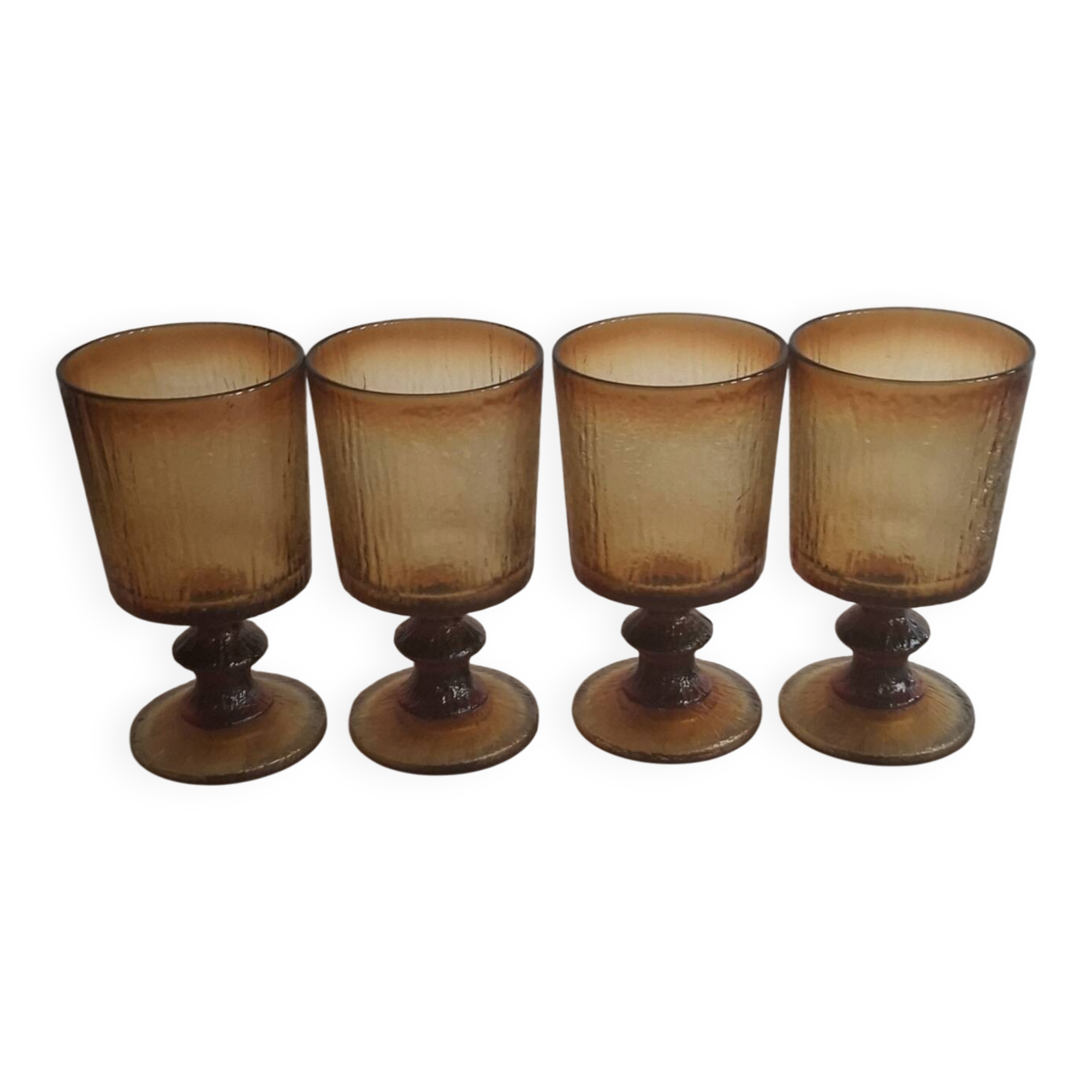 Set of four thick amber glass stemmed glasses.