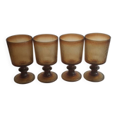 Set of four thick amber glass stemmed glasses.