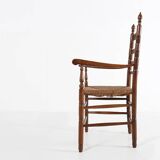 Antique wooden armchair with cane seat, France ca. 1900
