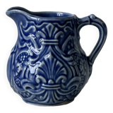 Old cream milk jug in slip
