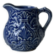 Old cream milk jug in slip