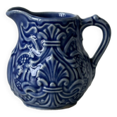 Old cream milk jug in slip