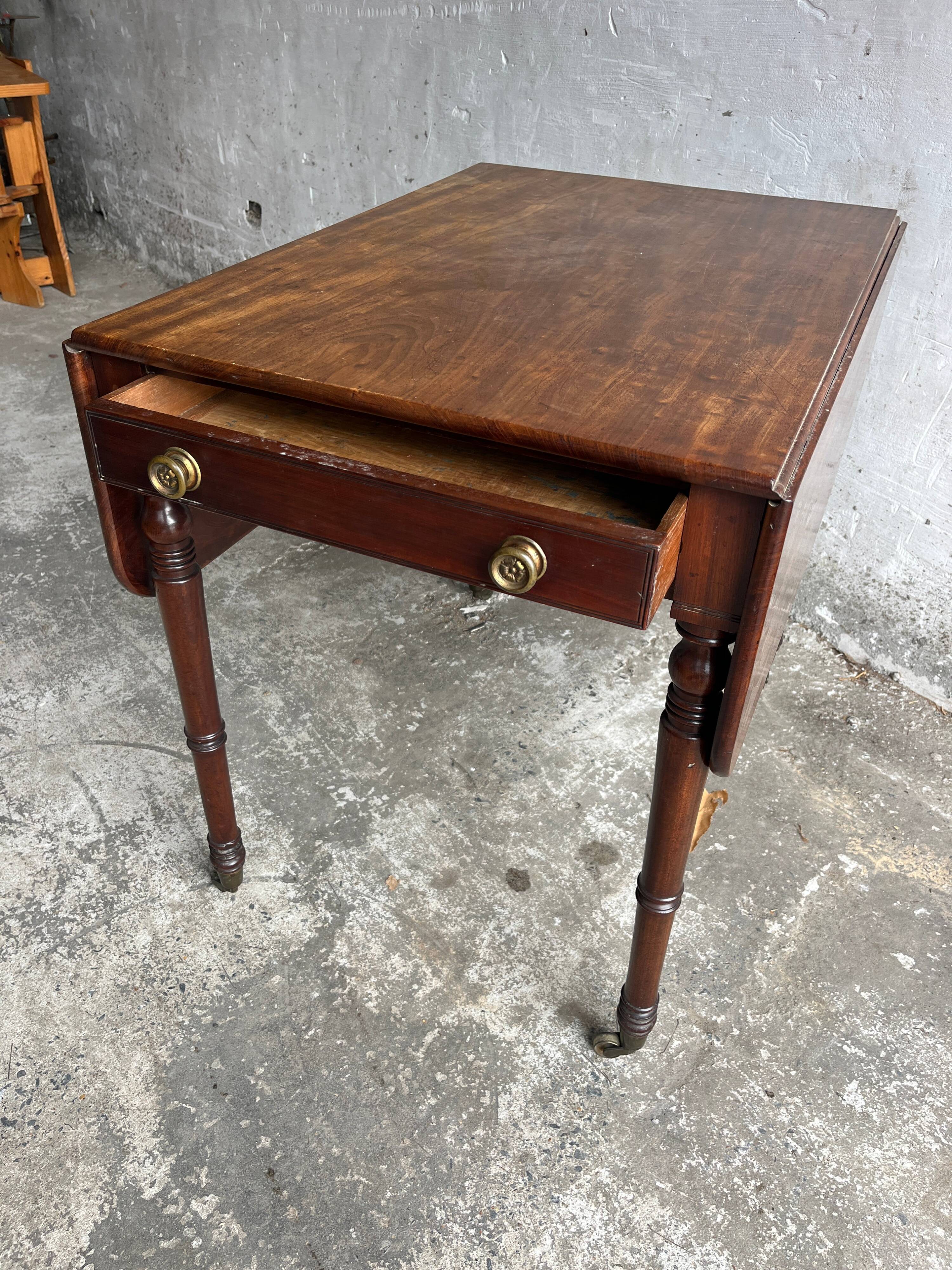 Antique drop-leaf side table on wheels