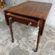 Antique drop-leaf side table on wheels