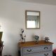 Antique mirror with a gilded frame and beaded border.