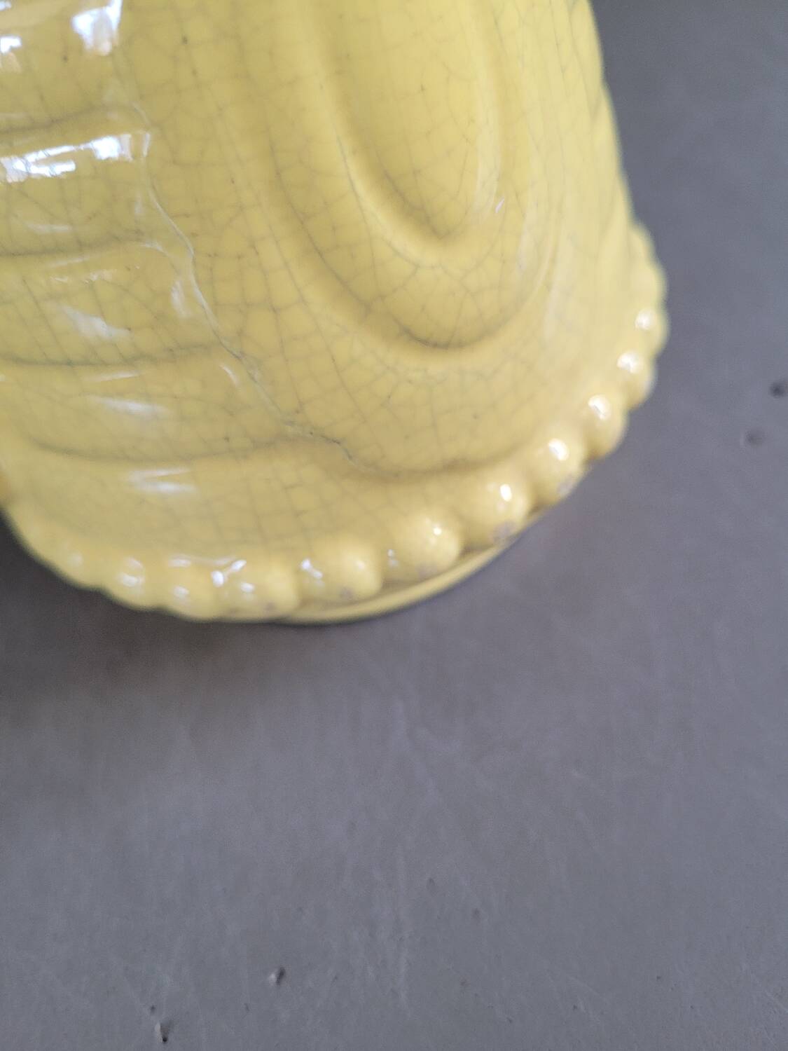 Yellow milk jug with reliefs