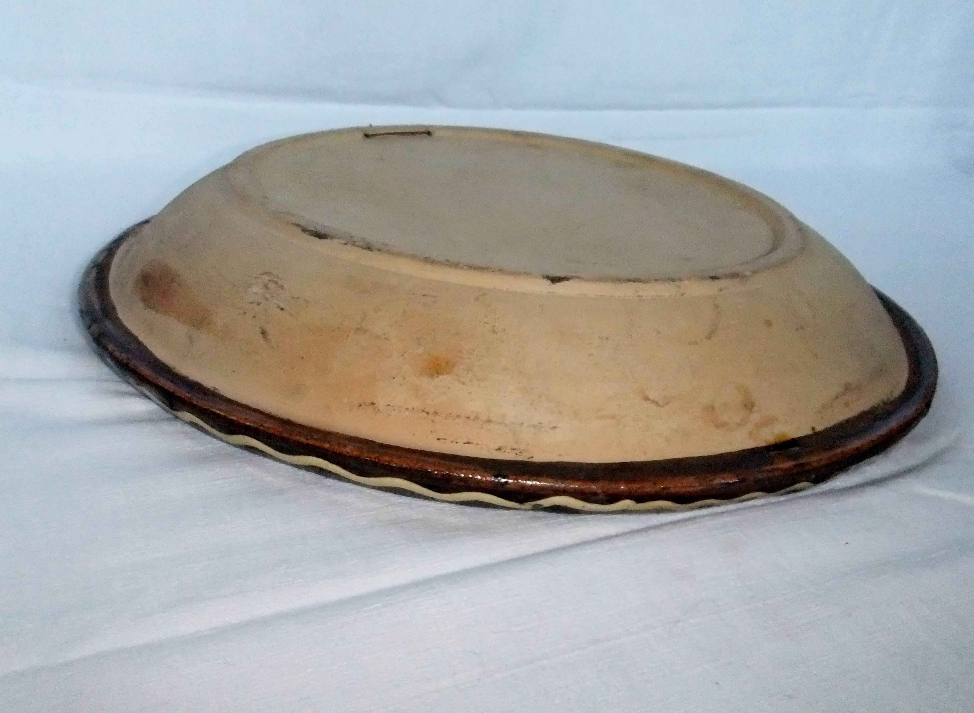 old terracotta dish decorated with rooster