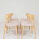 Set of 6 pale pink dining chairs in natural wood.