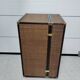 Wardrobe trunk on casters in mahogany and woven rattan.