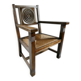 Armchair in carved solid wood with straw seat