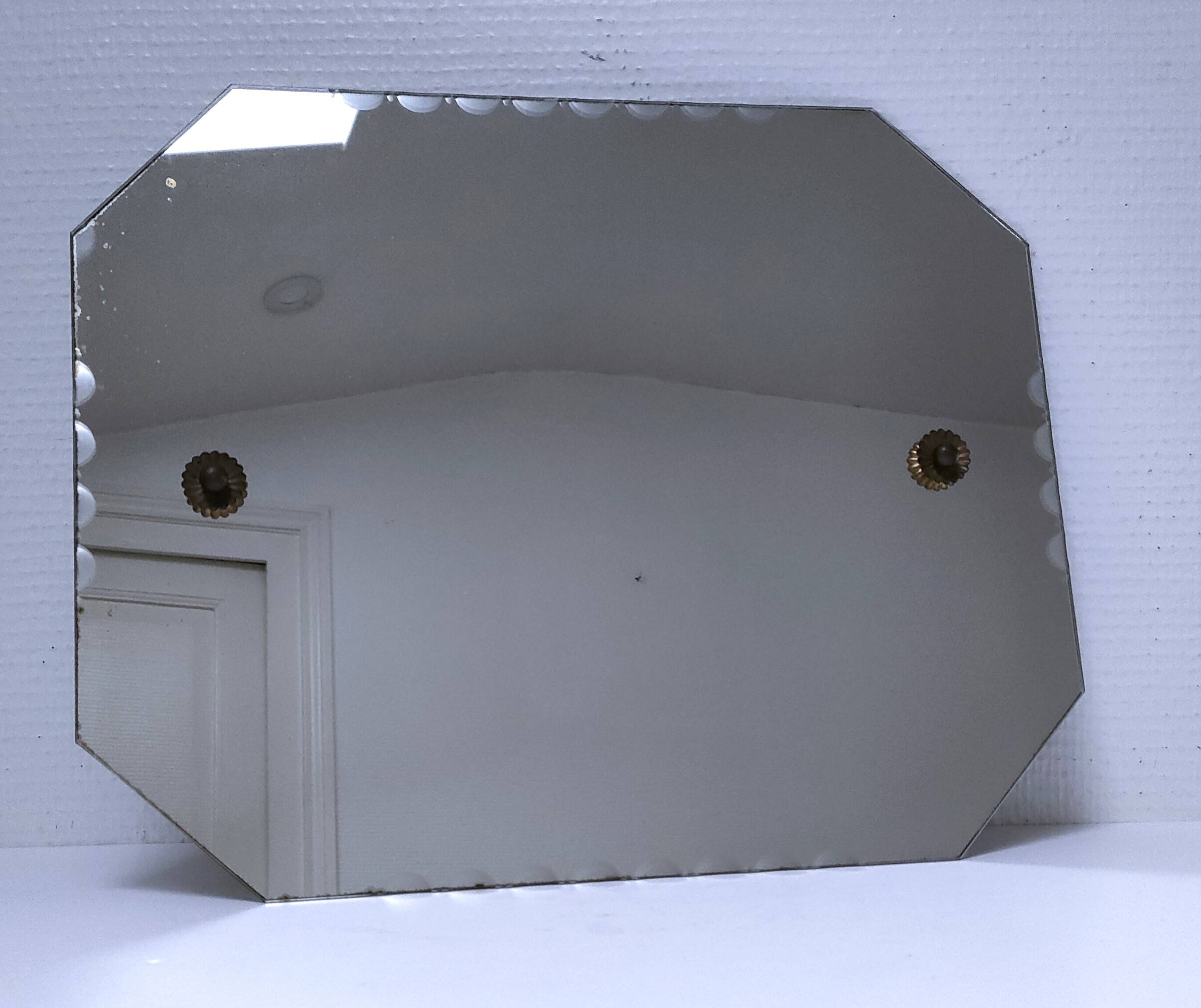 Octagonal mirror with brass hubcaps from the 60s