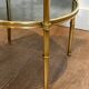 Round bronze side table with triple shelves of églomisé mirrors from Maison Baguès