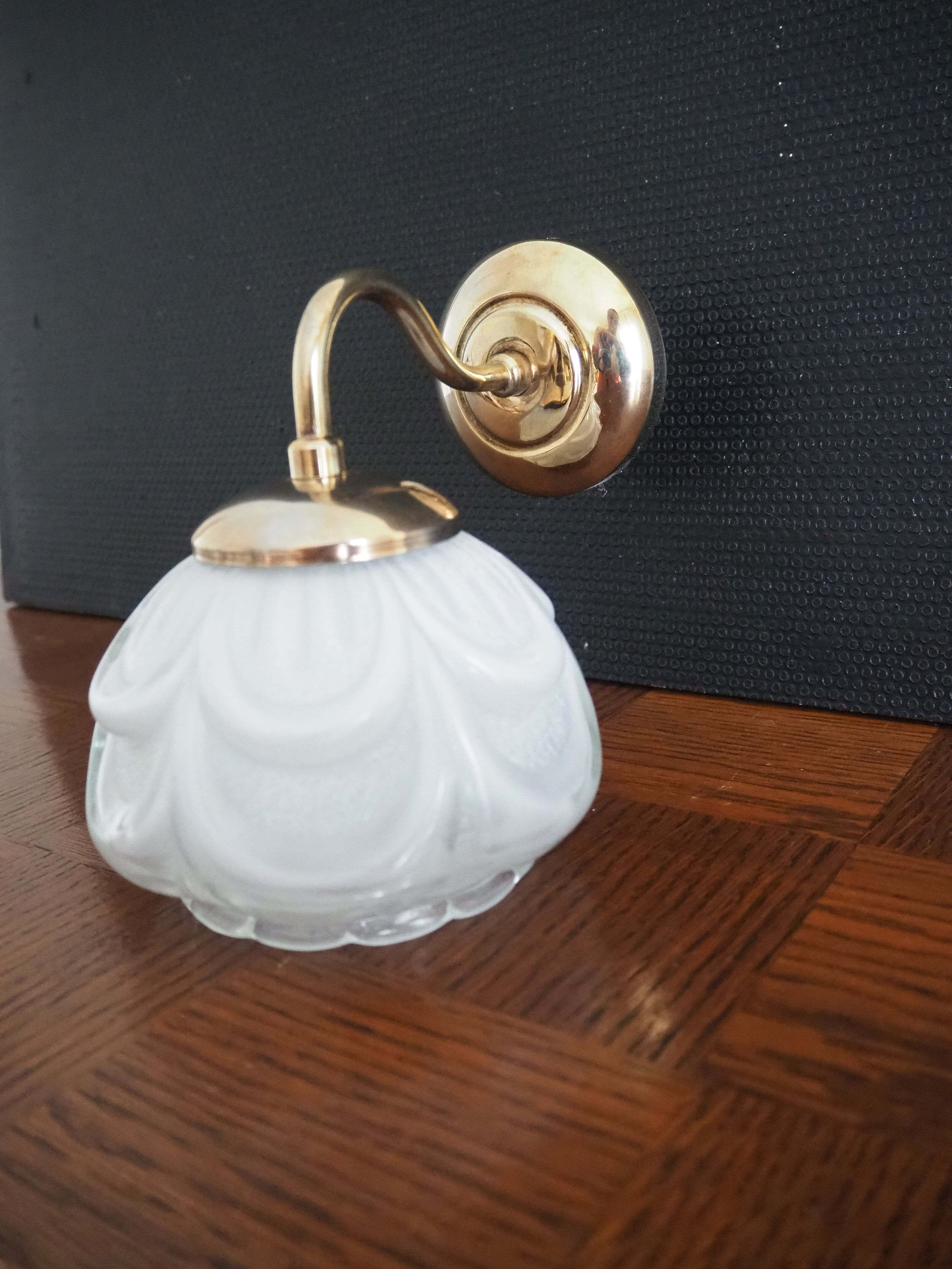 Brass wall lamp and white glass globe from the 1950s-1960s.