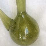Green transparent glass bottle. Long-beaked biot.