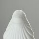 Set of white porcelain ramekins, ribbed shell shape.