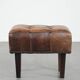 Beautiful sheepskin ottoman on high legs and beautiful warm colours