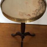 Wooden pedestal table on marble