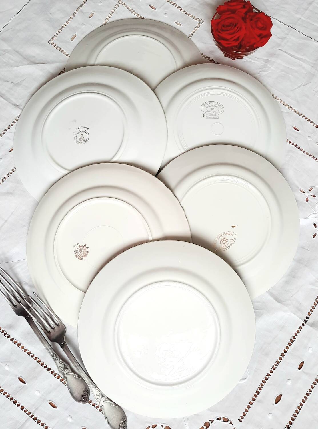 Old mismatched earthenware dinner plates accompanied by a deep dish