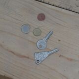 Small old wooden table with inclusion of coins and keys