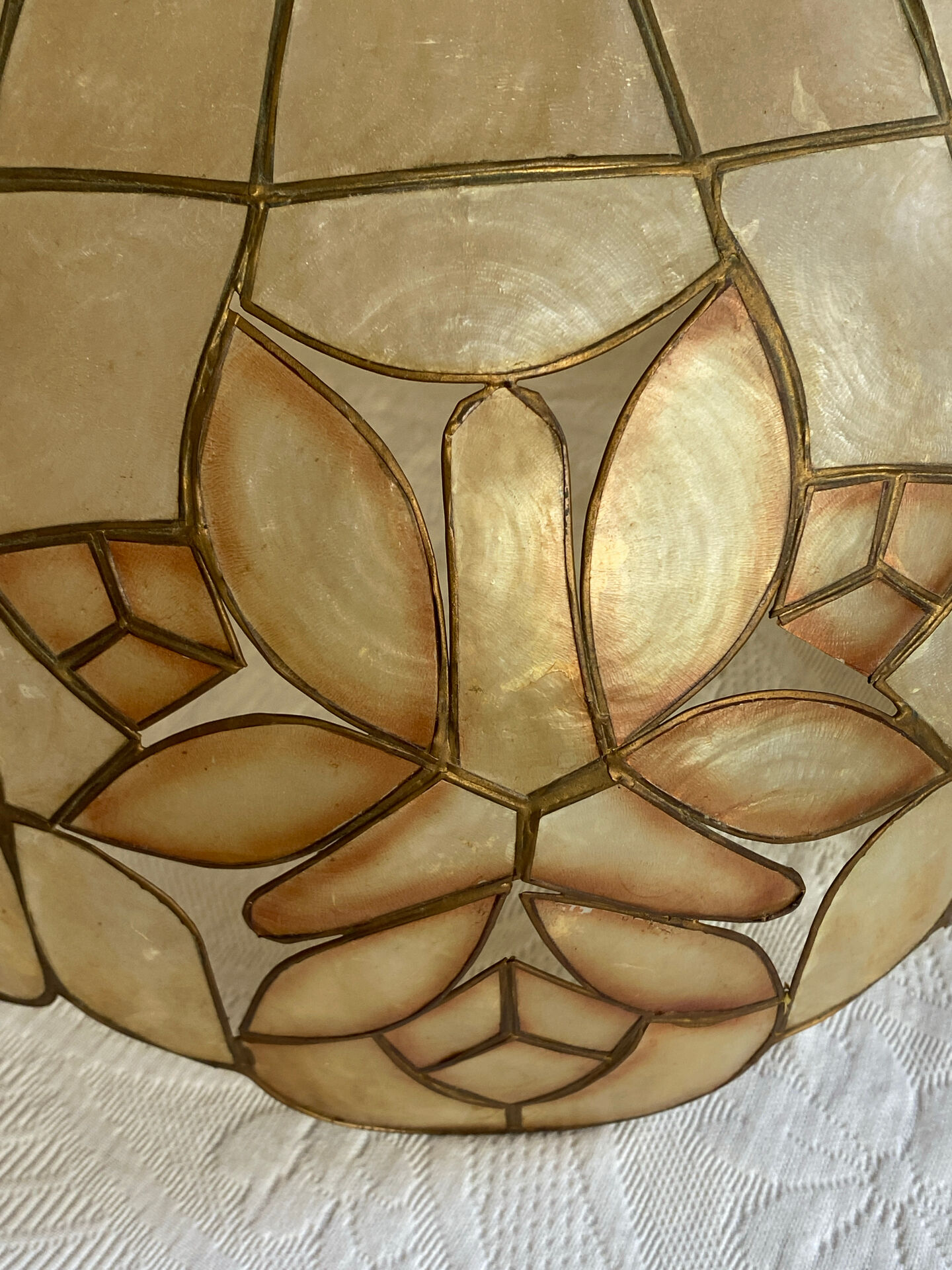 Large mother-of-pearl and brass chandelier with floral decoration.