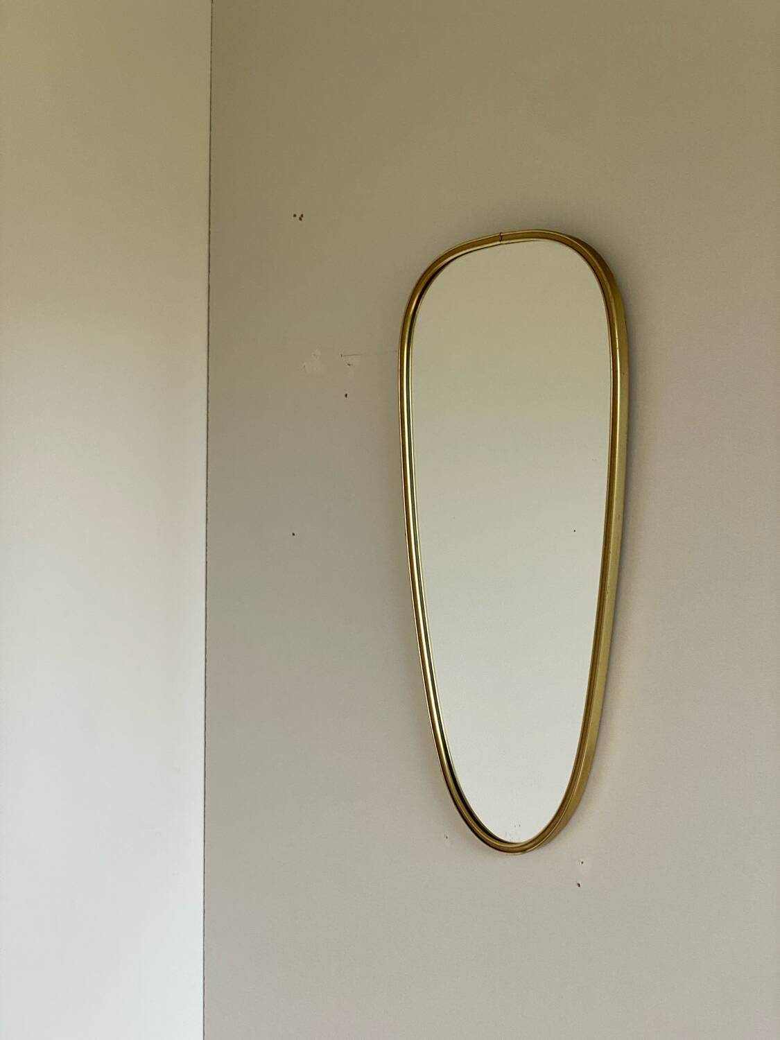 Vintage brass mirror in rear-view mirror shape