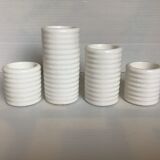 Four white earthenware candle holders