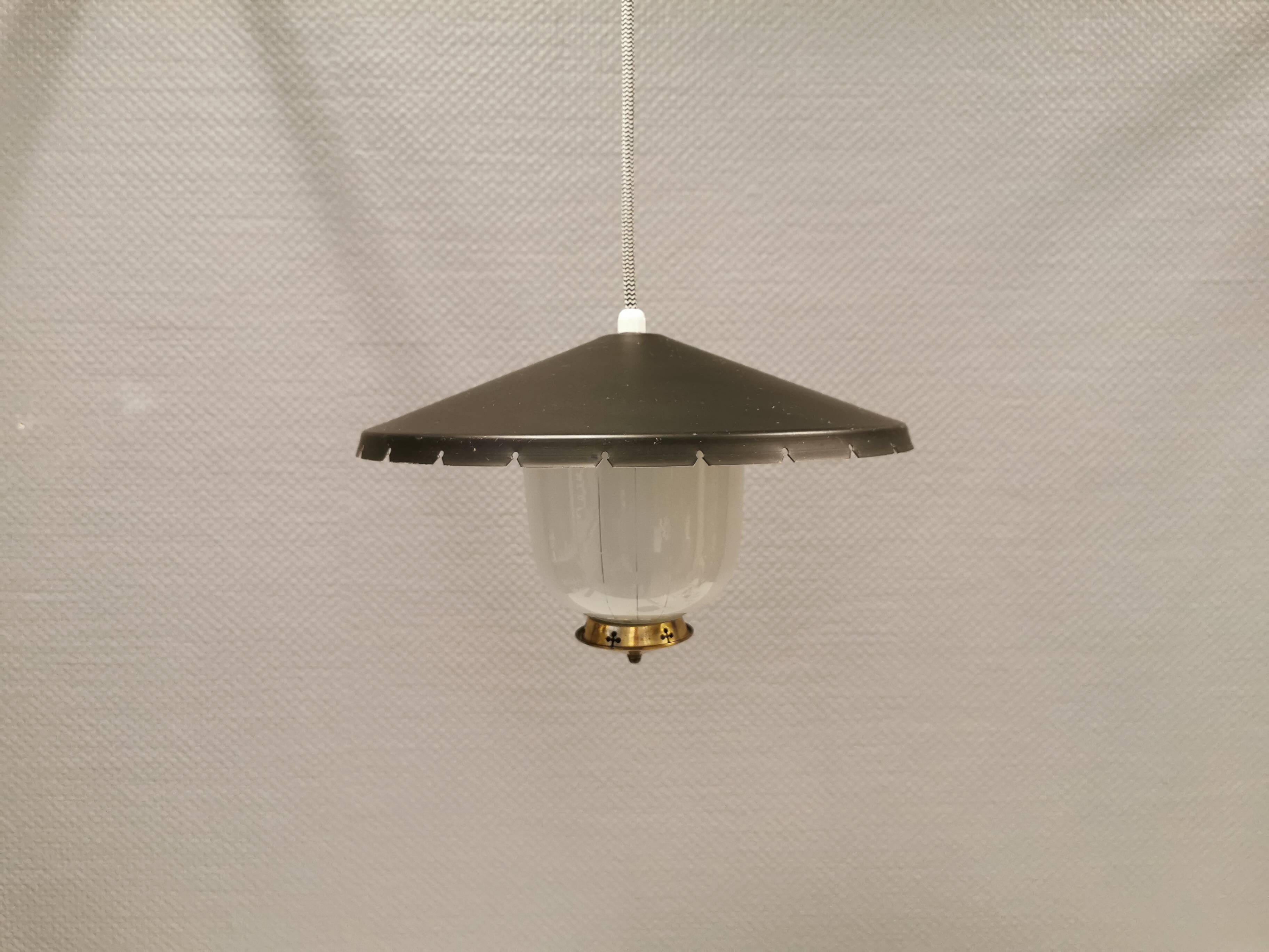 Hanging lamp in glass with black lacquered metal shade and brass base.