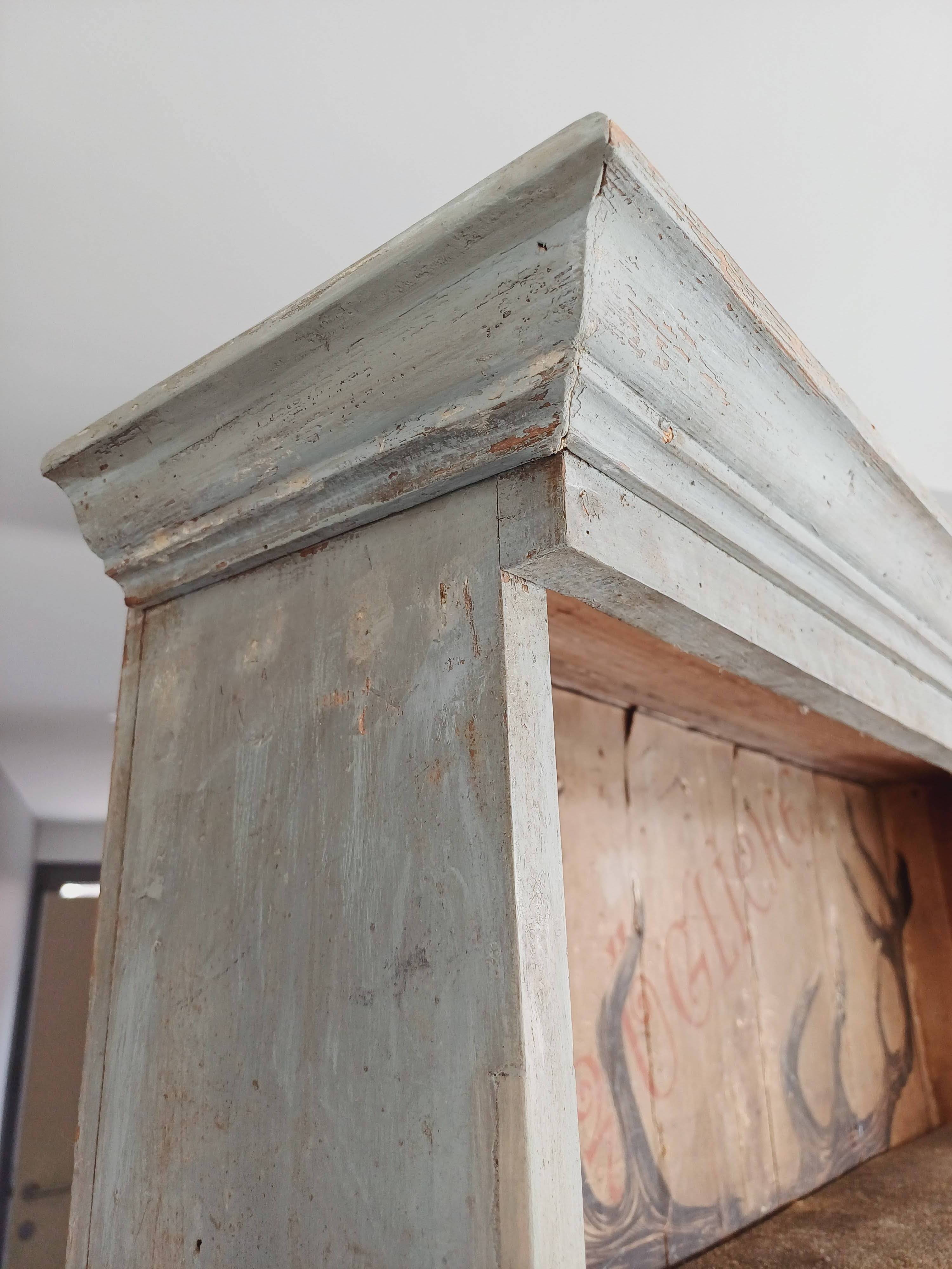 Craft cabinet with drawers with a very old tobacco advertisement in the background