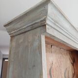 Craft cabinet with drawers with a very old tobacco advertisement in the background