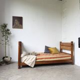 Brutalist style bed with chain and straw