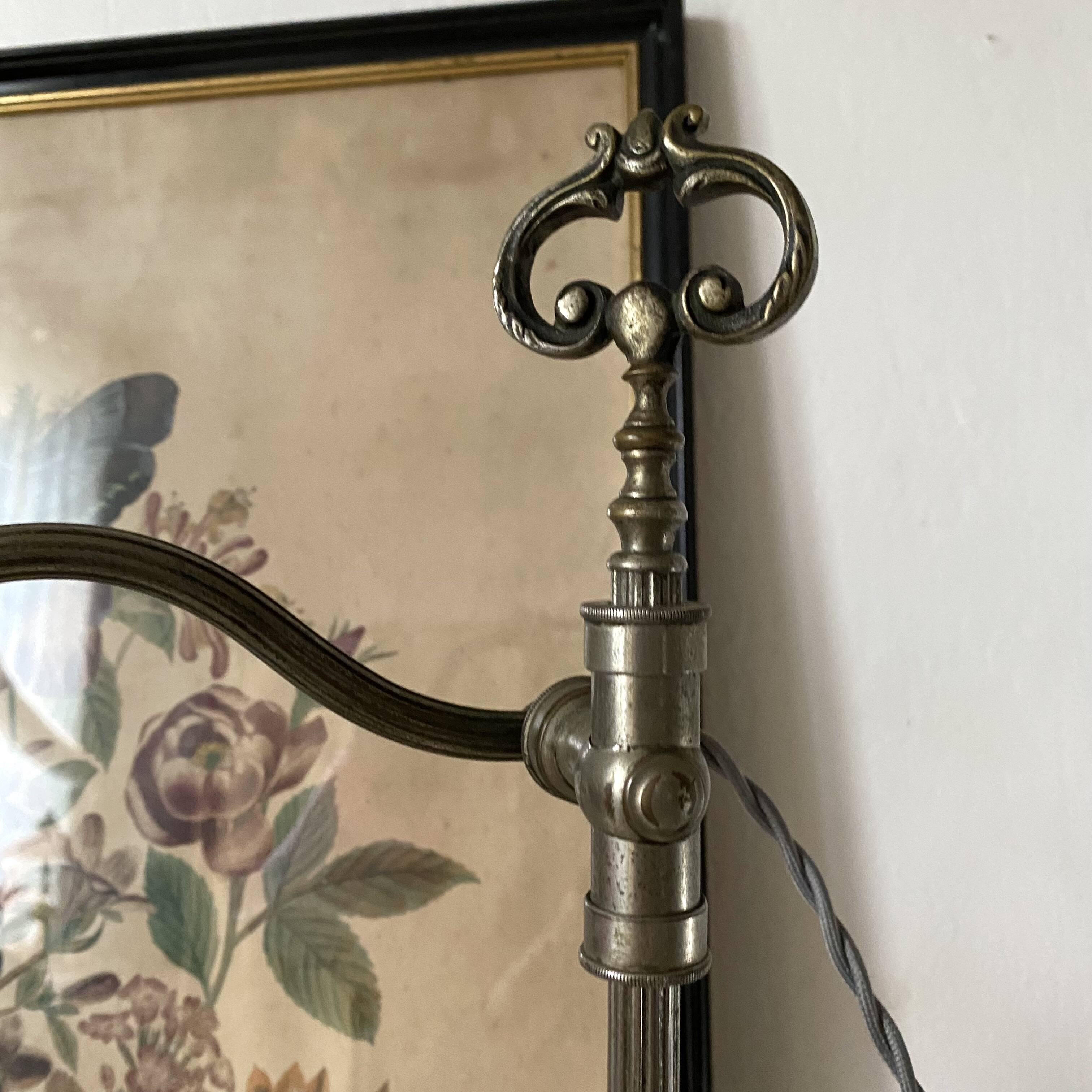 Antique jeweller's lamp, silver-plated base, frosted pink glass shade.