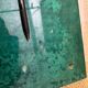 Aldo Tura side table in aqua green with brass legs and lower drawer.