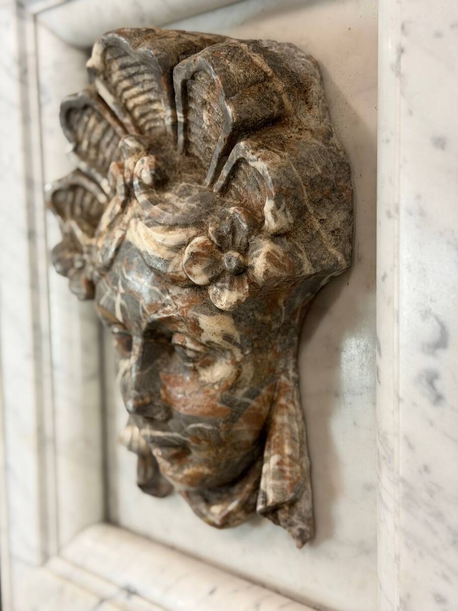 Female mascaron in grey Ardennes marble from the Regency period, 18th century.