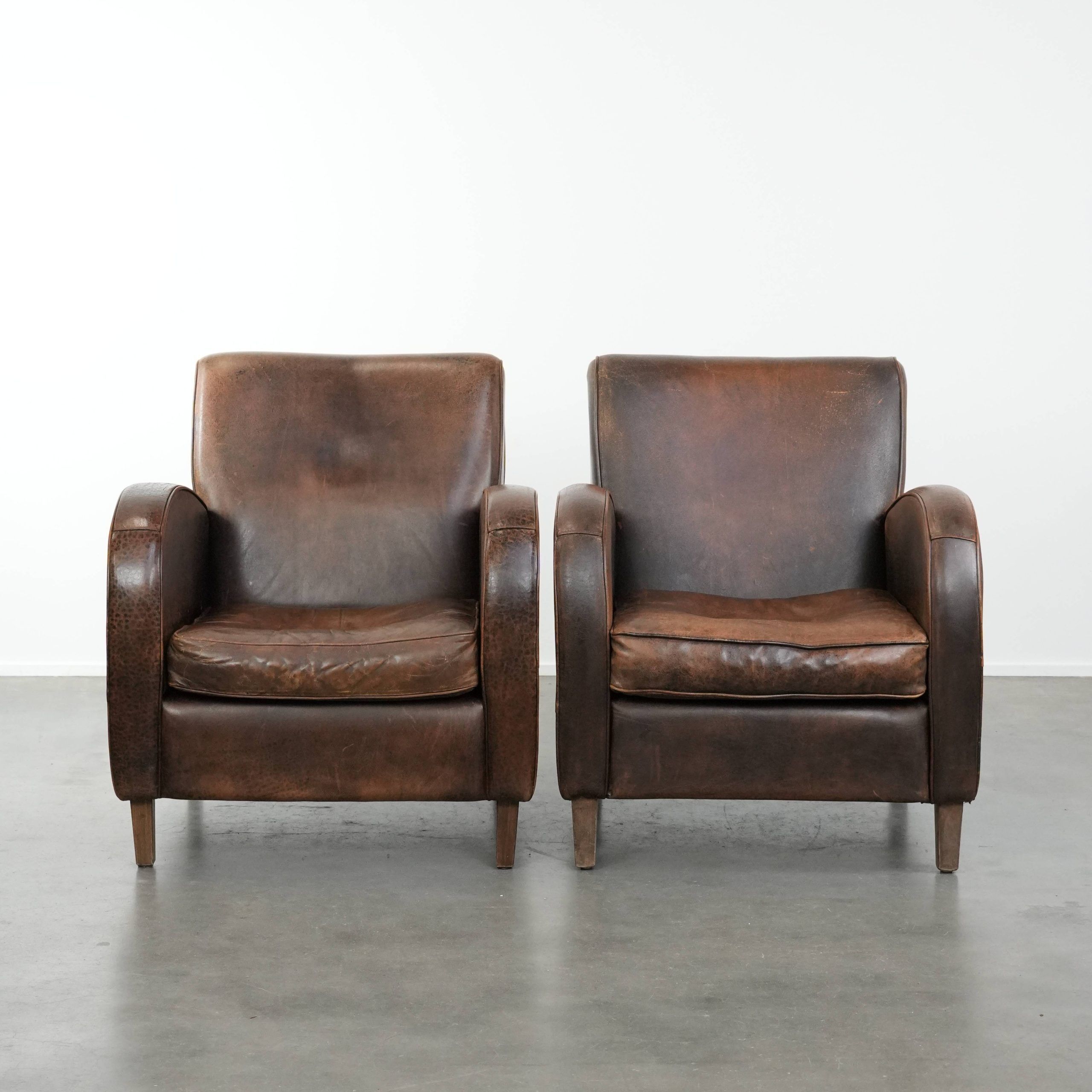 Set of two vintage sheepskin leather design armchairs in a cognac colour