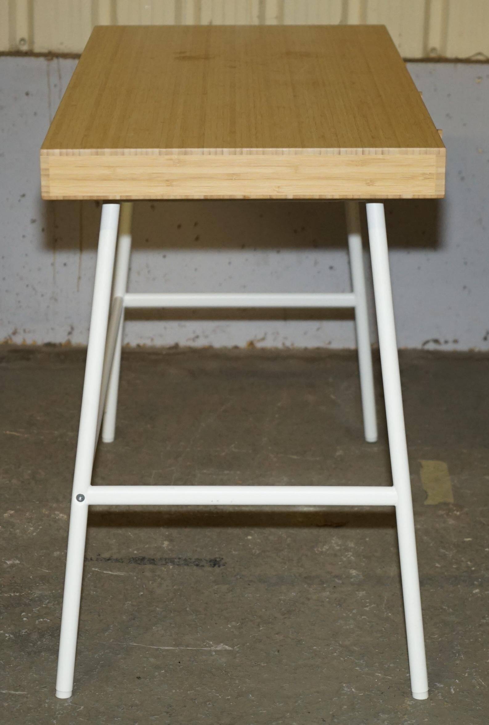 Small bamboo desk with three drawers.