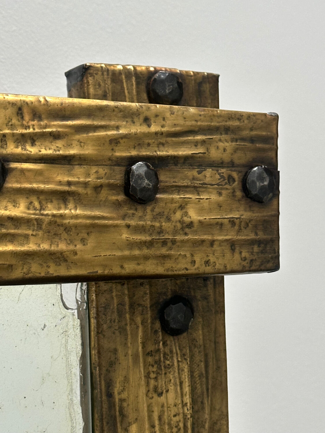 Brutalist mirror with a hammered copper and brass frame.